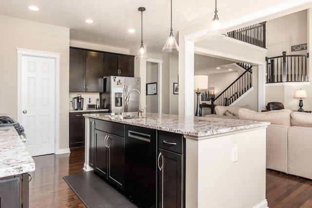 kitchen featuring stainless steel fridge, open floor plan, dark wood-style floors, light stone countertops, and recessed lighting