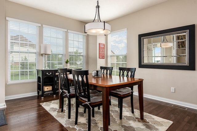 dining room featuring baseboards and dark wood-style floors