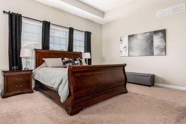 bedroom with light carpet and baseboards