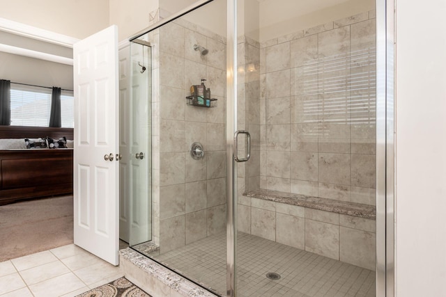 bathroom with tile patterned flooring and a shower stall