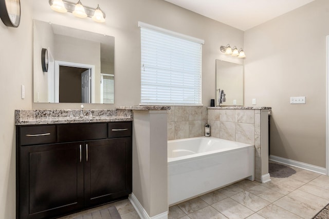 full bathroom with a bath, baseboards, and vanity