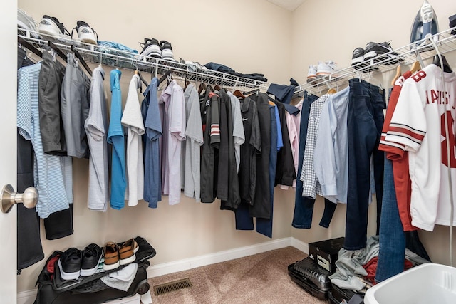 walk in closet featuring carpet