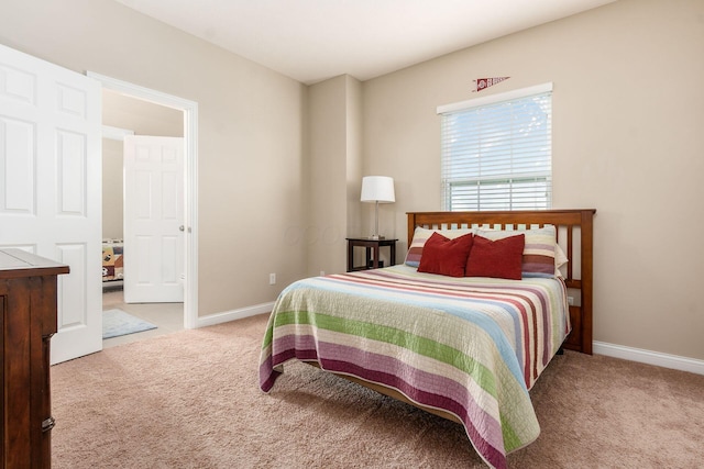 bedroom featuring carpet floors and baseboards