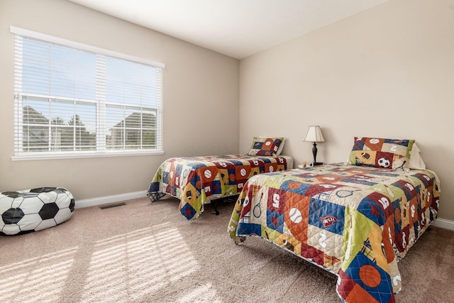 carpeted bedroom with baseboards