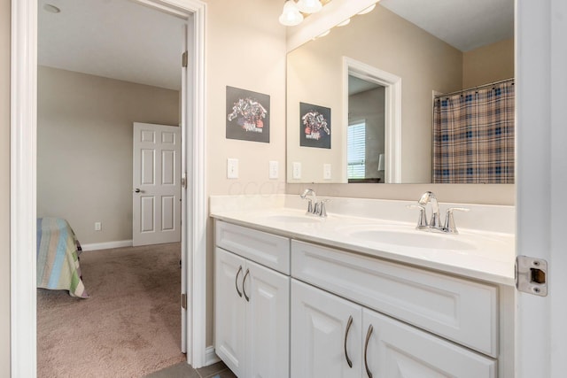 bathroom featuring double vanity and baseboards