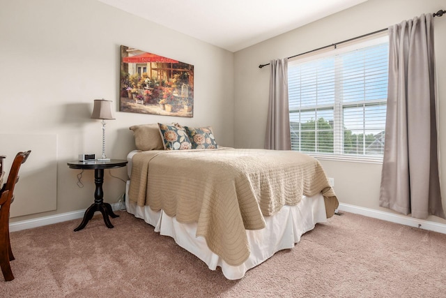 carpeted bedroom featuring baseboards