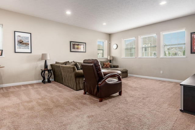 cinema room with light colored carpet, recessed lighting, and baseboards