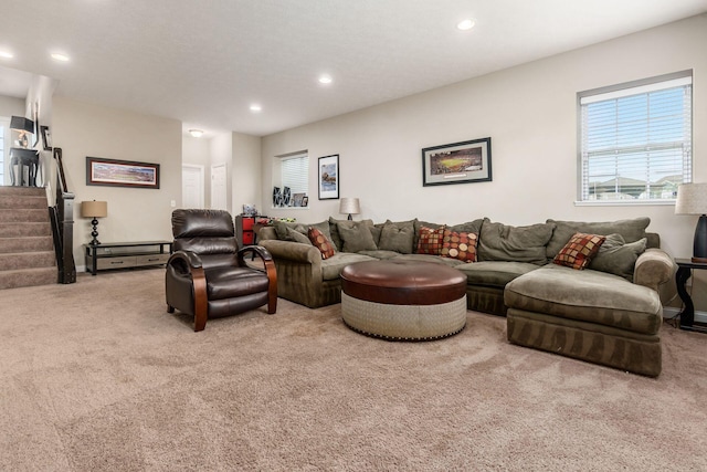 living area with carpet flooring, plenty of natural light, recessed lighting, and stairs