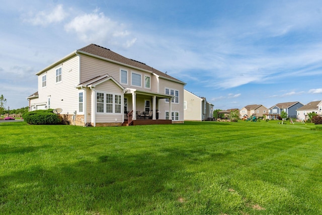 rear view of property featuring a yard