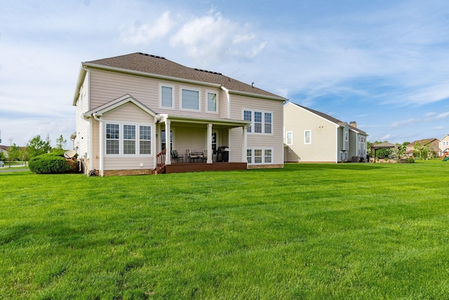 back of property with a lawn