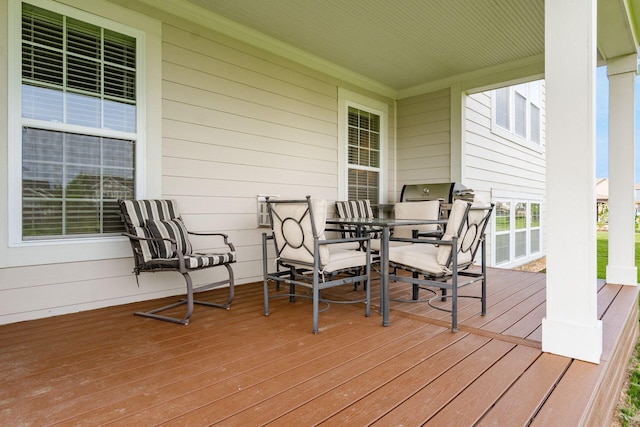 wooden terrace featuring outdoor dining area
