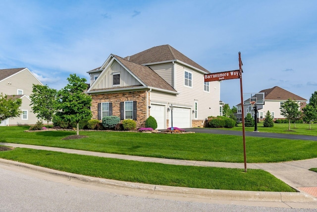 view of front of home with stone siding, driveway, a garage, a front yard, and board and batten siding