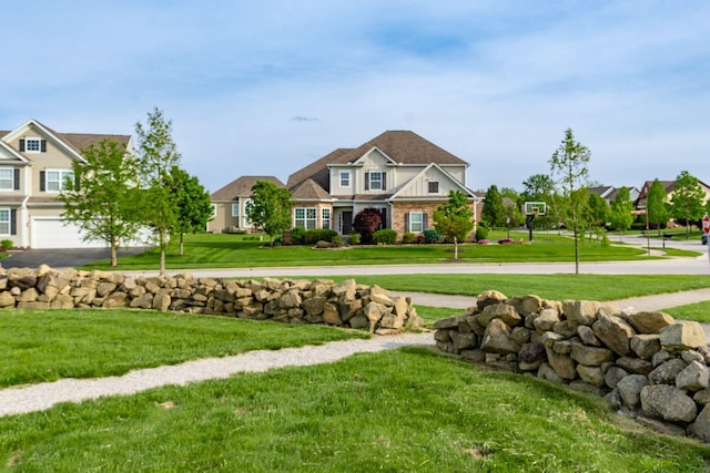 view of grassy yard featuring driveway and an attached garage