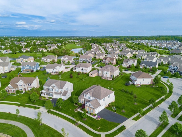 aerial perspective of suburban area with a nearby body of water