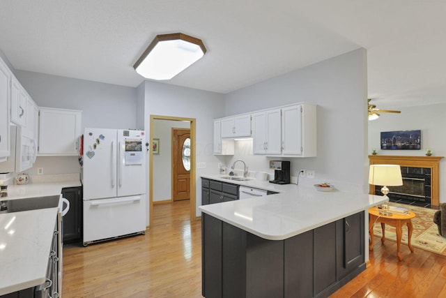 80 Baltimore Somerset Rd NW, Baltimore, OH 43105 - kitchen with white appliances, a sink, light wood-style floors, and a peninsula