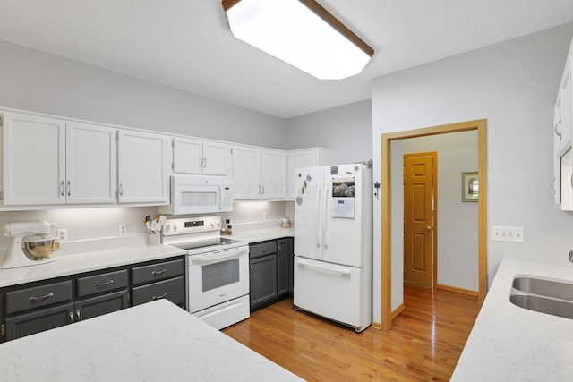 80 Baltimore Somerset Rd NW, Baltimore, OH 43105 - kitchen with white appliances, white cabinetry, a sink, and light wood finished floors