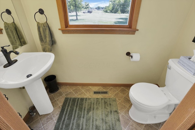 80 Baltimore Somerset Rd NW, Baltimore, OH 43105 - bathroom featuring toilet, baseboards, tile patterned flooring, and a sink