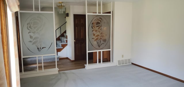 4993 Shadycrest Rd, Columbus, OH 43229 - carpeted entryway with stairs, baseboards, and a chandelier