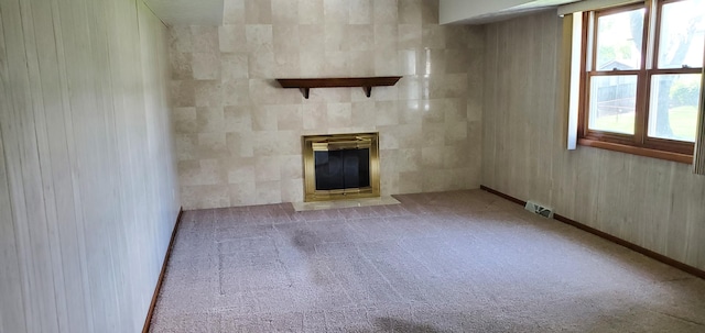 4993 Shadycrest Rd, Columbus, OH 43229 - unfurnished living room featuring a tiled fireplace, carpet, and baseboards