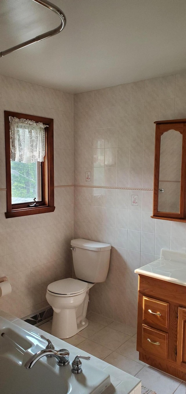 4993 Shadycrest Rd, Columbus, OH 43229 - bathroom with tile walls, tile patterned flooring, toilet, and vanity