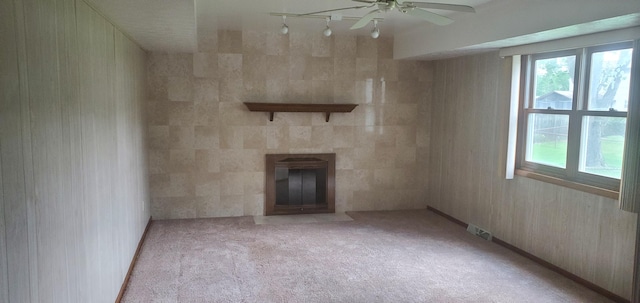 4993 Shadycrest Rd, Columbus, OH 43229 - unfurnished living room featuring a tiled fireplace, a ceiling fan, and carpet flooring