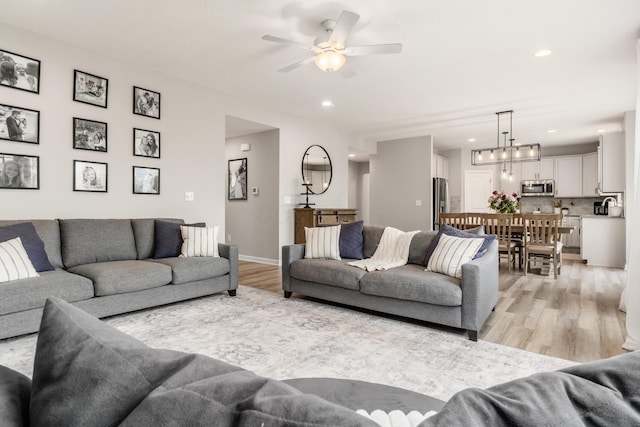 417 Oakland Hills Loop, Commercial Point, OH 43116 - living area with light wood-style floors, ceiling fan, recessed lighting, and baseboards