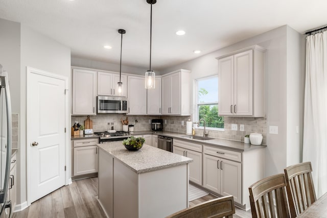 417 Oakland Hills Loop, Commercial Point, OH 43116 - kitchen with a sink, stainless steel appliances, light wood finished floors, backsplash, and recessed lighting