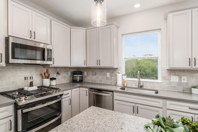 417 Oakland Hills Loop, Commercial Point, OH 43116 - kitchen featuring appliances with stainless steel finishes, a sink, white cabinetry, backsplash, and recessed lighting