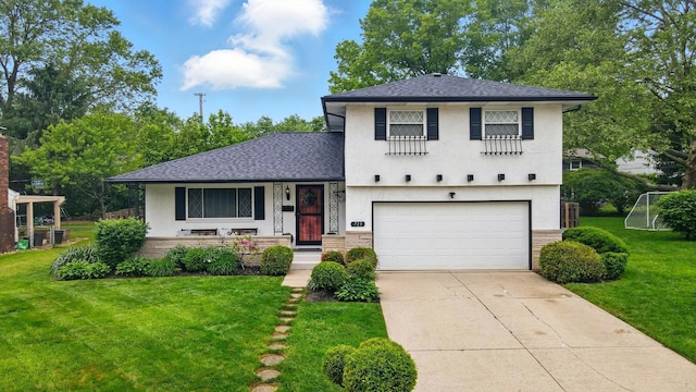 723 W Winmar Pl, Westerville, OH 43081 - tri-level home with an attached garage, concrete driveway, a front yard, a shingled roof, and stucco siding