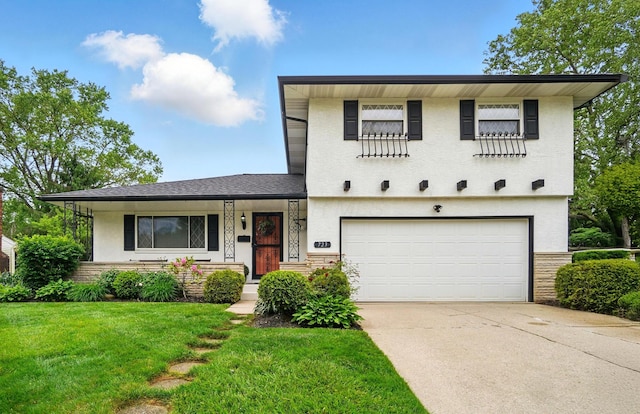 723 W Winmar Pl, Westerville, OH 43081 - view of front of house featuring an attached garage, concrete driveway, a front yard, and stucco siding