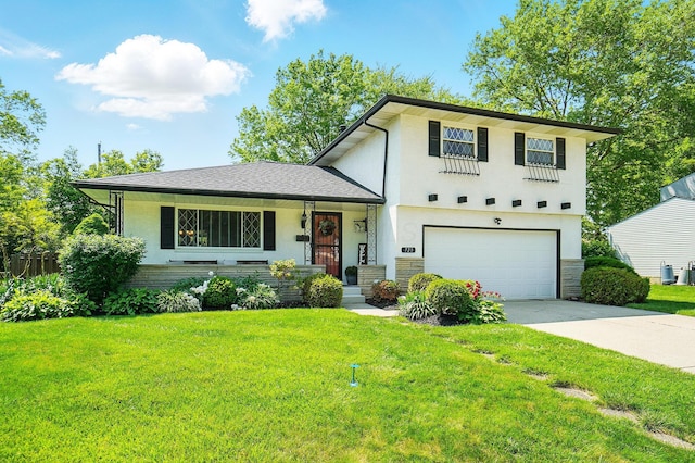 723 W Winmar Pl, Westerville, OH 43081 - split level home featuring an attached garage, a front lawn, driveway, stucco siding, and stone siding
