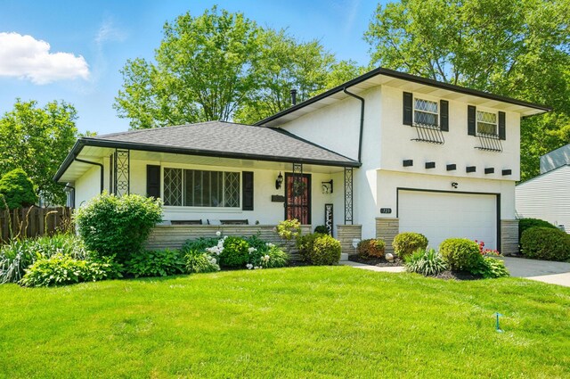 723 W Winmar Pl, Westerville, OH 43081 - tri-level home with an attached garage, concrete driveway, and stucco siding