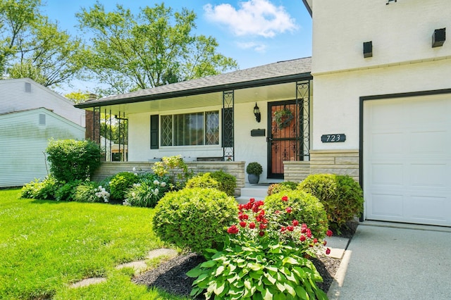 723 W Winmar Pl, Westerville, OH 43081 - view of exterior entry featuring a porch, stucco siding, a yard, and stone siding
