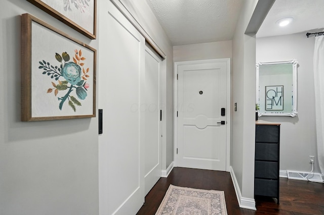 723 W Winmar Pl, Westerville, OH 43081 - doorway with dark wood finished floors, baseboards, and a textured ceiling