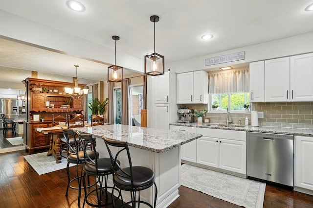 723 W Winmar Pl, Westerville, OH 43081 - kitchen with dishwasher, a sink, a kitchen island, light stone countertops, and recessed lighting