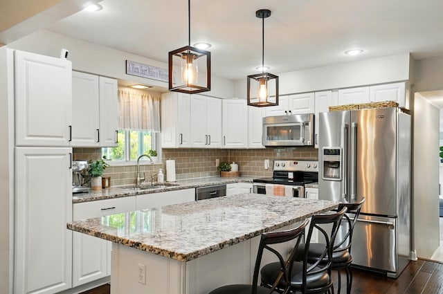 723 W Winmar Pl, Westerville, OH 43081 - kitchen with appliances with stainless steel finishes, a sink, dark wood-style flooring, backsplash, and white cabinetry