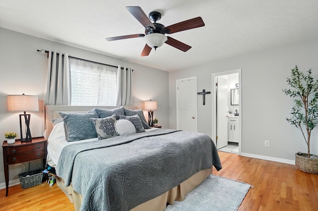 723 W Winmar Pl, Westerville, OH 43081 - bedroom featuring light wood-style flooring, baseboards, connected bathroom, and ceiling fan