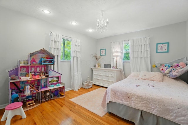 723 W Winmar Pl, Westerville, OH 43081 - bedroom featuring multiple windows, a chandelier, wood finished floors, recessed lighting, and baseboards