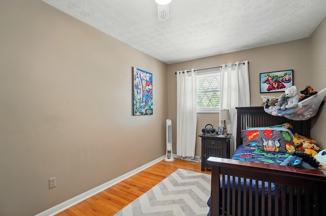 723 W Winmar Pl, Westerville, OH 43081 - bedroom with baseboards, light wood-style floors, and a textured ceiling