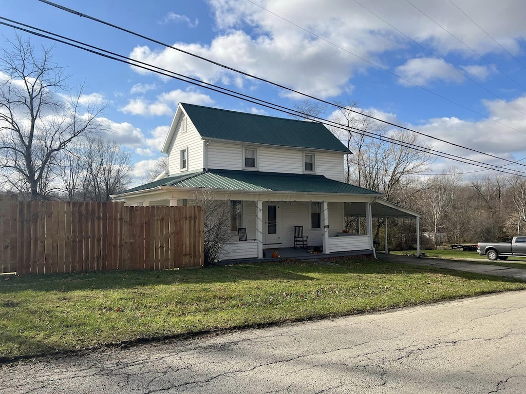 113 N High St, Leesburg, OH 45135 - farmhouse inspired home with a porch, metal roof, asphalt driveway, and a carport