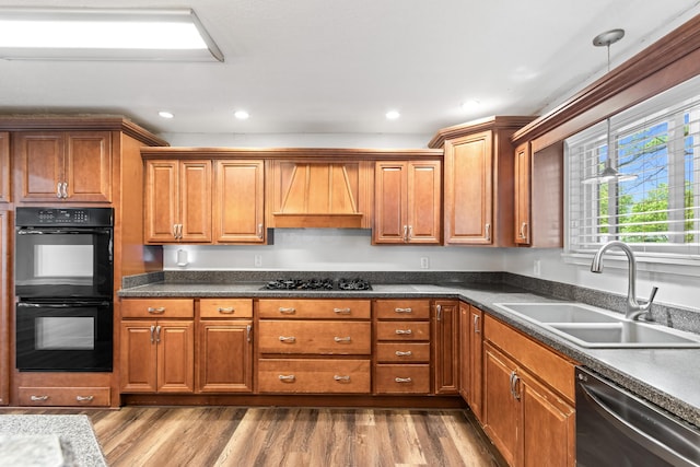 293 Flint Ridge Dr, Columbus, OH 43230 - kitchen with black appliances, a sink, custom range hood, brown cabinetry, and recessed lighting