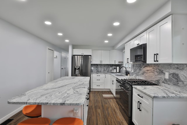 327 Warlock Ct, Columbus, OH 43230 - kitchen with black appliances, a sink, recessed lighting, dark wood finished floors, and decorative backsplash