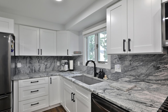 327 Warlock Ct, Columbus, OH 43230 - kitchen with a sink, freestanding refrigerator, white cabinets, and light stone countertops