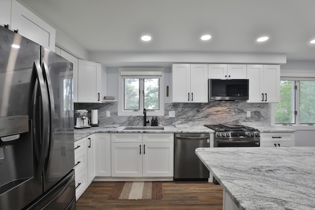 327 Warlock Ct, Columbus, OH 43230 - kitchen with appliances with stainless steel finishes, a sink, tasteful backsplash, dark wood-type flooring, and recessed lighting