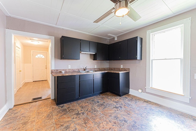 167 Essex St, Newark, OH 43055 - kitchen featuring plenty of natural light, a sink, baseboards, and light countertops