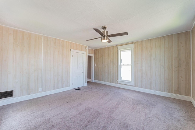 167 Essex St, Newark, OH 43055 - carpeted empty room with ceiling fan, wood walls, and a textured ceiling