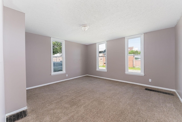 167 Essex St, Newark, OH 43055 - empty room with baseboards, carpet flooring, and a textured ceiling