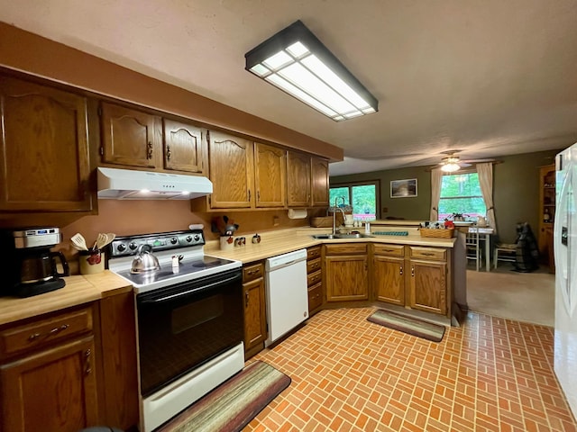 346 Instone Dr, Reynoldsburg, OH 43068 - kitchen featuring range with electric cooktop, white dishwasher, under cabinet range hood, a sink, and a peninsula
