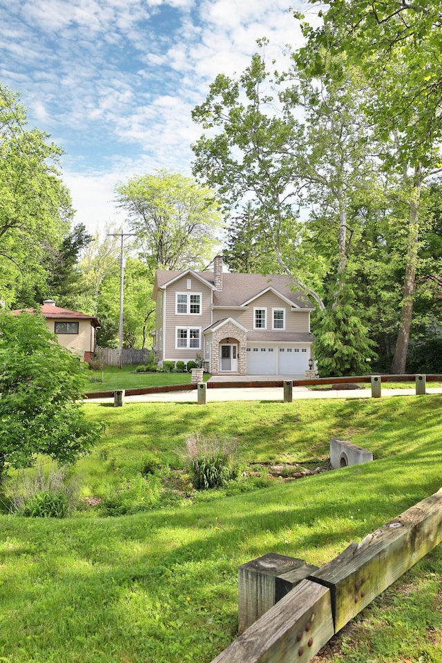 258 Canyon Dr, Columbus, OH 43214 - rear view of property with an attached garage, a chimney, and stone siding