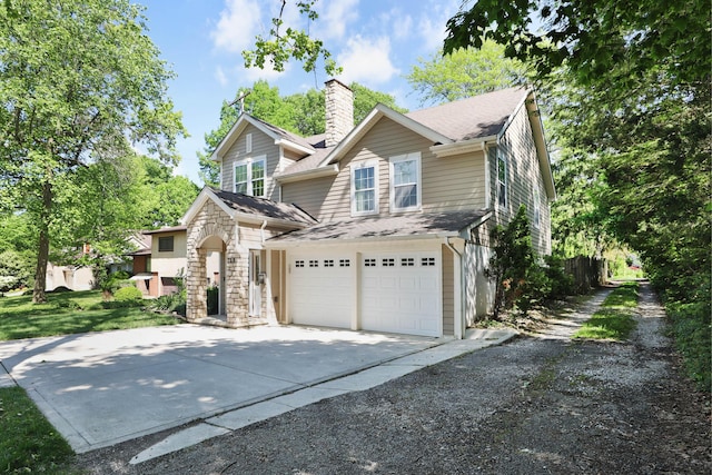 258 Canyon Dr, Columbus, OH 43214 - traditional-style home featuring concrete driveway, a chimney, an attached garage, and a shingled roof